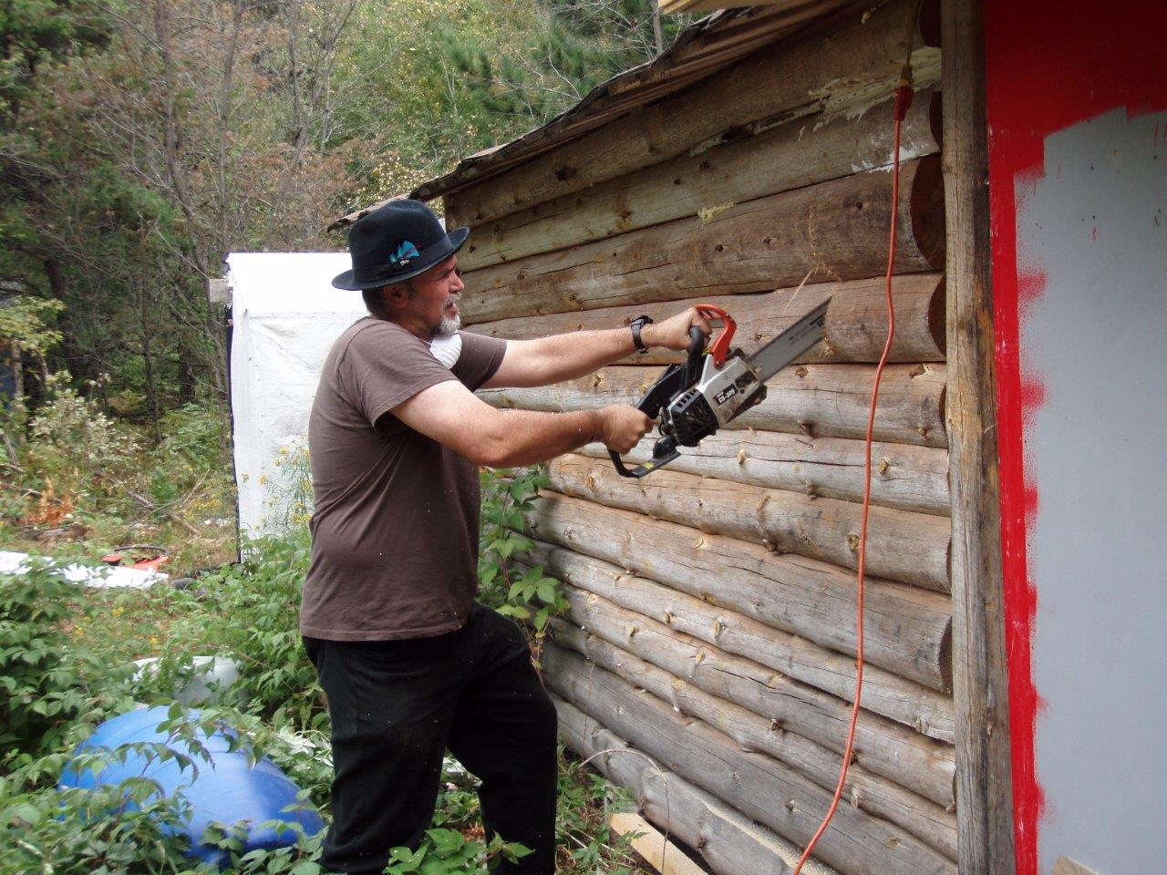 Bill Frey Cutting New Window in Log Cabin (1)