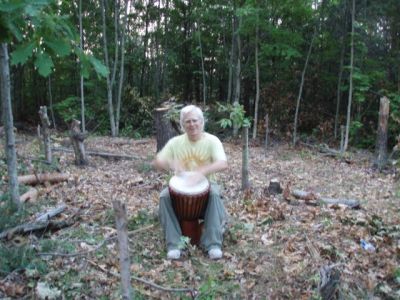 Robin Armstrong drumming in the circle
